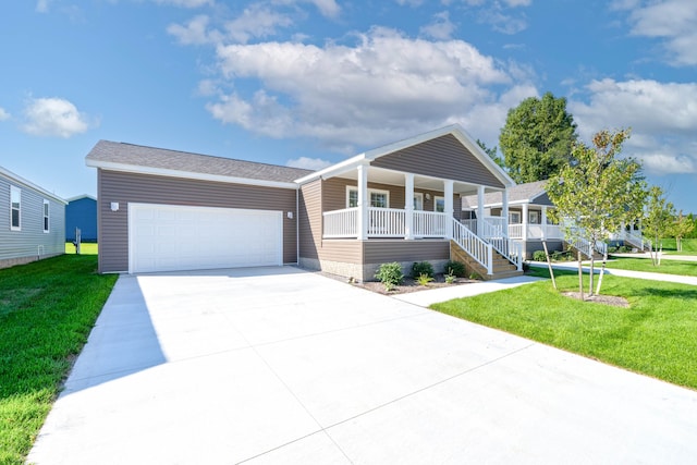 view of front facade with covered porch, a garage, and a front lawn