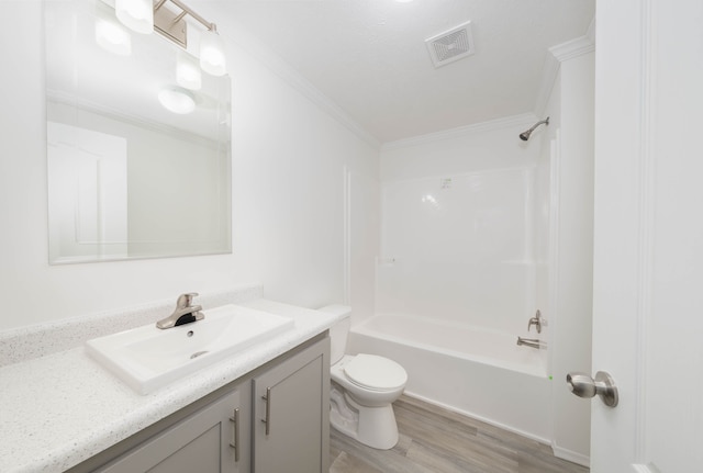 full bathroom with washtub / shower combination, wood-type flooring, toilet, vanity, and ornamental molding