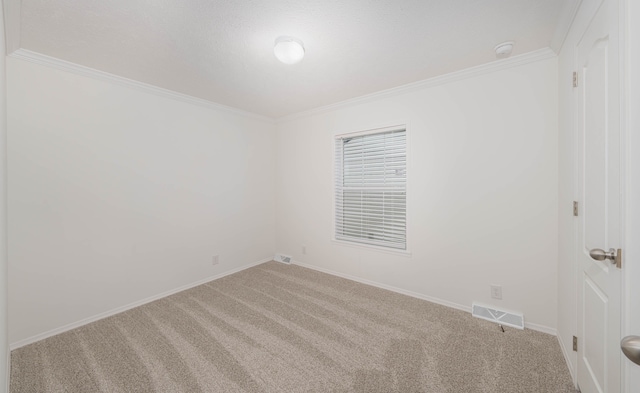 empty room featuring light colored carpet and ornamental molding