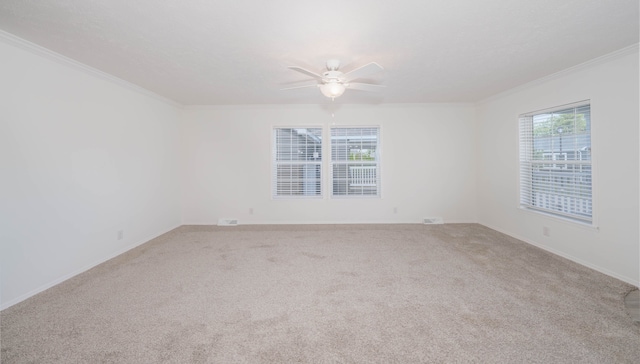 spare room with light carpet, ceiling fan, and ornamental molding