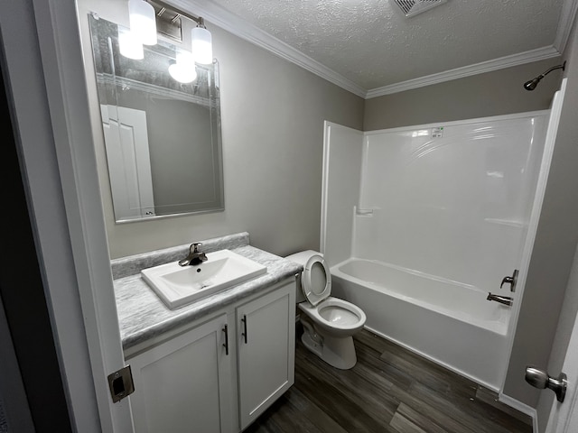 full bathroom with tub / shower combination, ornamental molding, a textured ceiling, vanity, and hardwood / wood-style floors