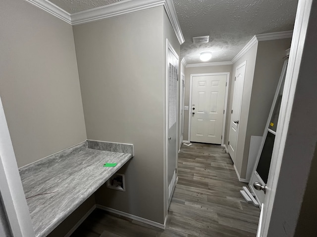 hall with a textured ceiling, crown molding, and dark wood-type flooring