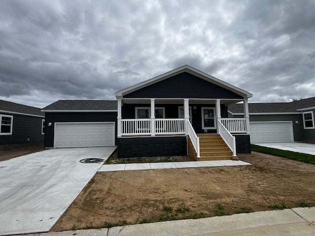 view of front of house featuring a porch and a garage