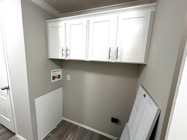 washroom featuring washer hookup, dark hardwood / wood-style floors, cabinets, and crown molding