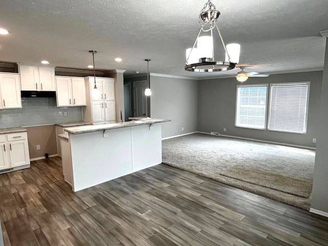 kitchen with ceiling fan, dark hardwood / wood-style flooring, white cabinets, and pendant lighting