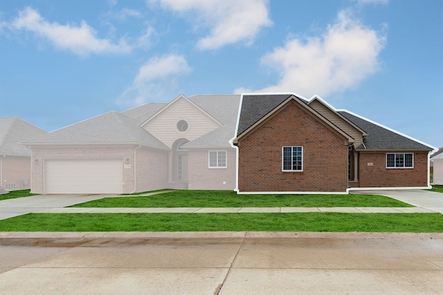 single story home featuring a garage and a front lawn