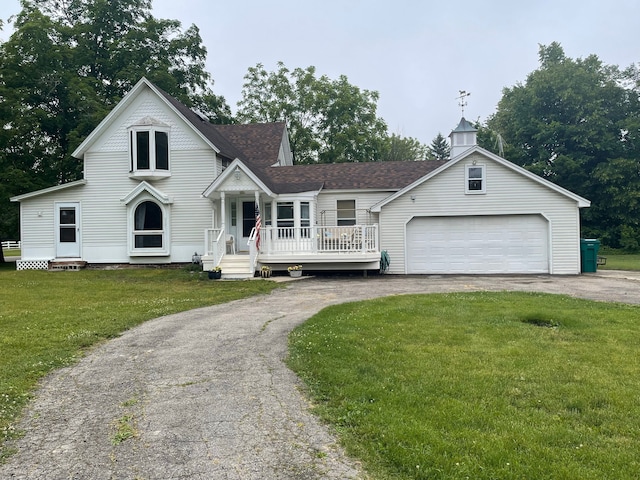 view of front of property featuring a front yard and a garage