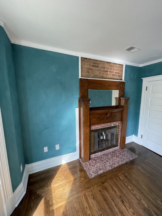 unfurnished living room featuring ornamental molding and a fireplace