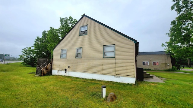 view of home's exterior with crawl space and a yard