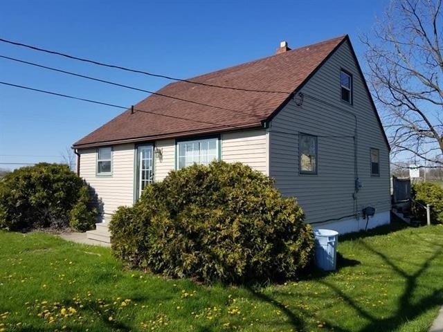 view of property exterior featuring a lawn