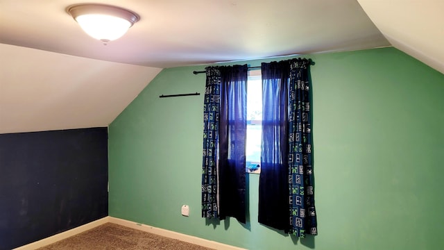 bonus room with lofted ceiling, carpet floors, and baseboards