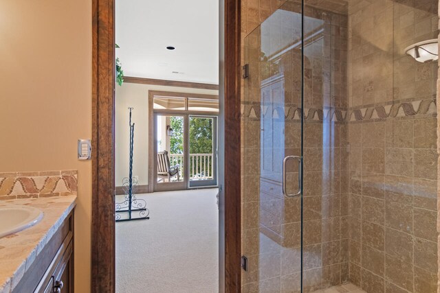 7545 Oyster Bay Dr Unit 4, Charlevoix, MI 49720 - full bath featuring vanity, a stall shower, ornamental molding, and baseboards