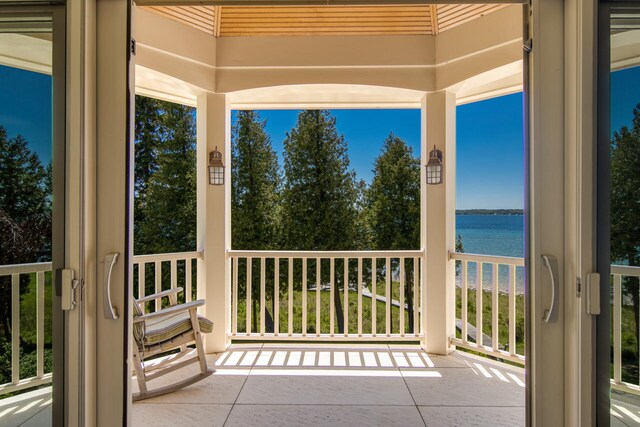 7545 Oyster Bay Dr Unit 4, Charlevoix, MI 49720 - porch with a water view