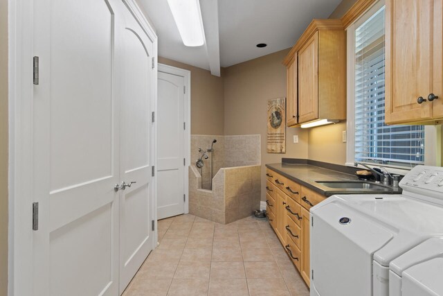 7545 Oyster Bay Dr Unit 4, Charlevoix, MI 49720 - laundry room with cabinet space, washer and dryer, light tile patterned floors, and healthy amount of natural light