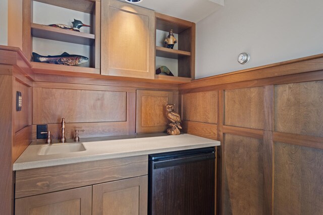 7545 Oyster Bay Dr Unit 4, Charlevoix, MI 49720 - kitchen featuring open shelves, a sink, dishwashing machine, and light countertops