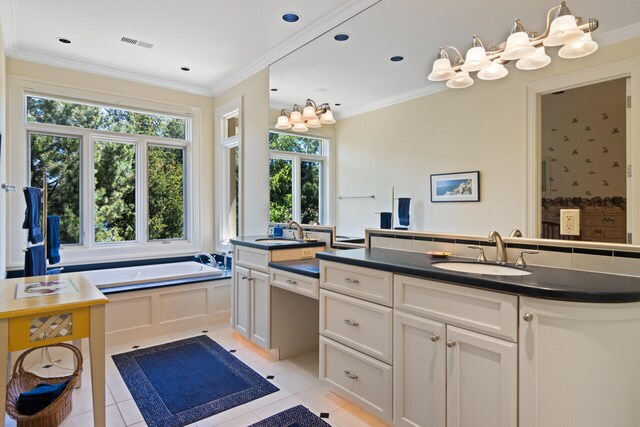 7545 Oyster Bay Dr Unit 4, Charlevoix, MI 49720 - bathroom with vanity, tile patterned floors, a garden tub, a chandelier, and crown molding