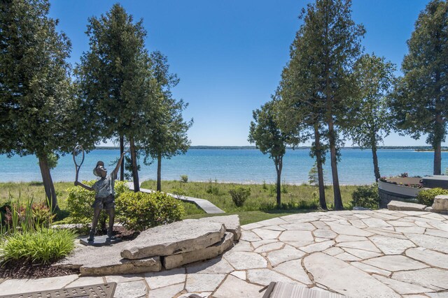 7545 Oyster Bay Dr Unit 4, Charlevoix, MI 49720 - view of patio / terrace featuring a water view