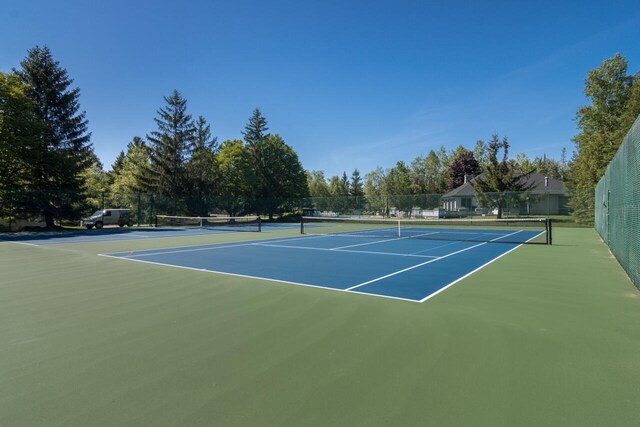 7545 Oyster Bay Dr Unit 4, Charlevoix, MI 49720 - view of tennis court featuring community basketball court