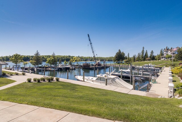 7545 Oyster Bay Dr Unit 4, Charlevoix, MI 49720 - dock with a lawn and a water view