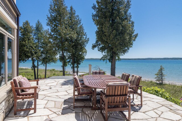7545 Oyster Bay Dr Unit 4, Charlevoix, MI 49720 - view of patio with a water view and outdoor dining space