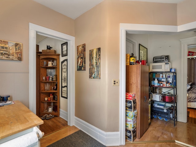 hallway with light hardwood / wood-style floors