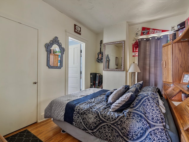 bedroom with hardwood / wood-style flooring