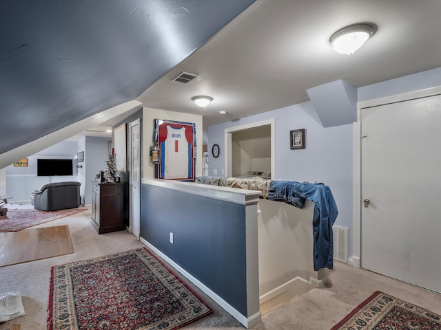 interior space with light colored carpet and lofted ceiling