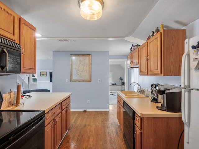 kitchen featuring lofted ceiling, sink, dark wood-type flooring, and black appliances