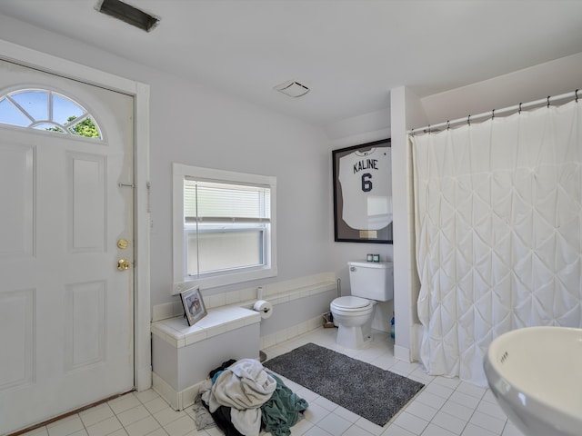 bathroom with tile patterned flooring, a shower with curtain, and toilet