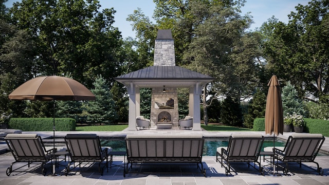 view of patio with an outdoor stone fireplace and a gazebo