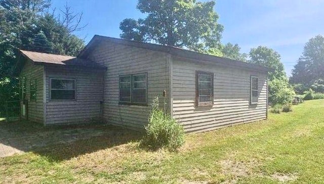 view of property exterior with a lawn