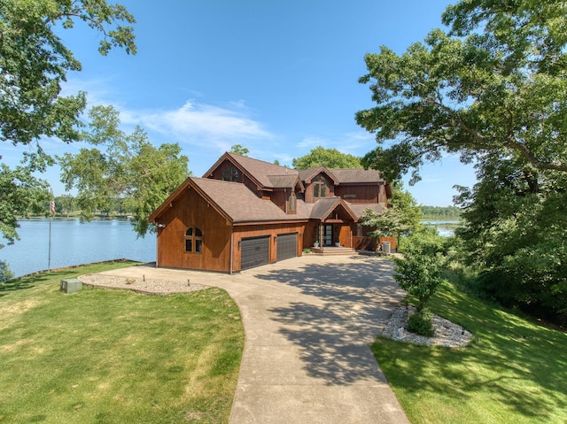 view of front of property with a front yard and a water view