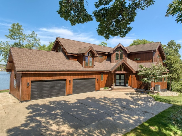 view of front of property featuring central AC and a garage