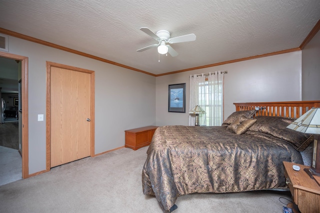 carpeted bedroom featuring a textured ceiling, ceiling fan, and ornamental molding