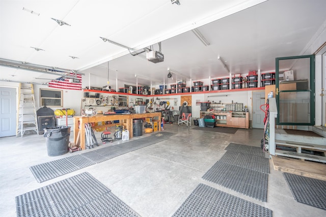 garage with a workshop area and a garage door opener