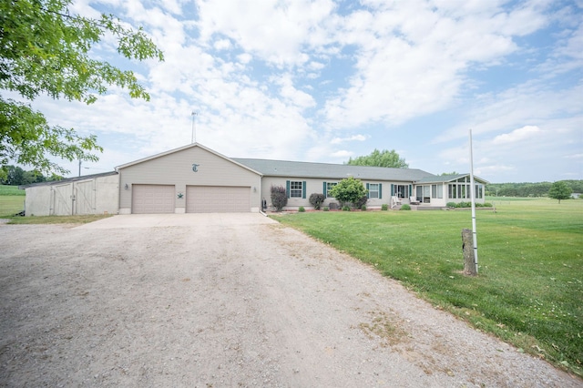 single story home featuring a front lawn and a garage