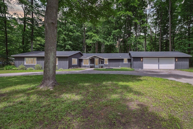 ranch-style home with a lawn and a garage