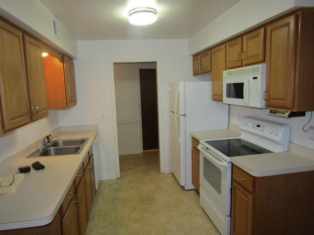 kitchen with white appliances and sink