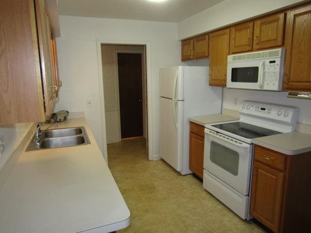 kitchen with white appliances and sink