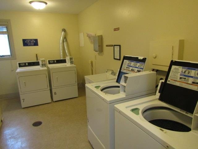 washroom with washer and dryer and sink