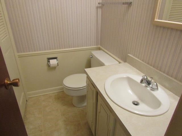 bathroom with tile patterned floors, vanity, and toilet