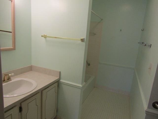 bathroom featuring vanity, tile patterned floors, and tub / shower combination