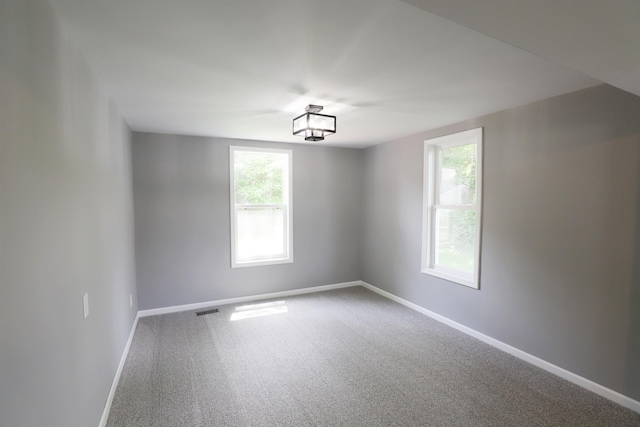 empty room featuring carpet flooring and a healthy amount of sunlight