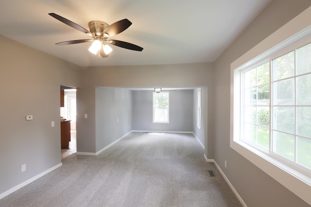 spare room with light carpet and ceiling fan