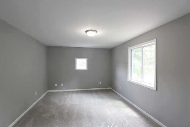 unfurnished room featuring carpet