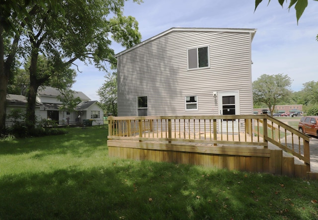 back of house with a lawn and a wooden deck