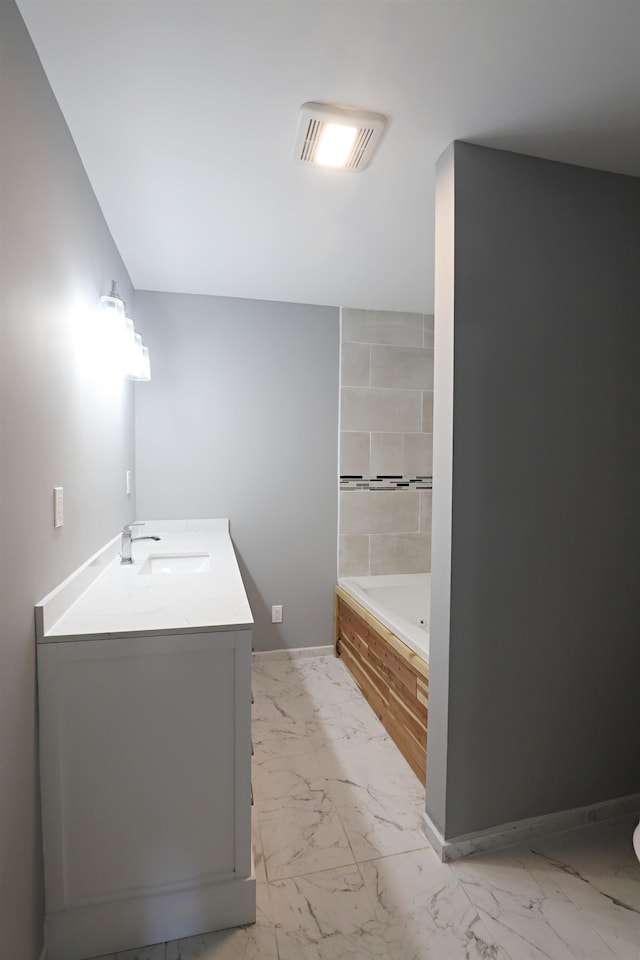 bathroom featuring vanity and a tub to relax in