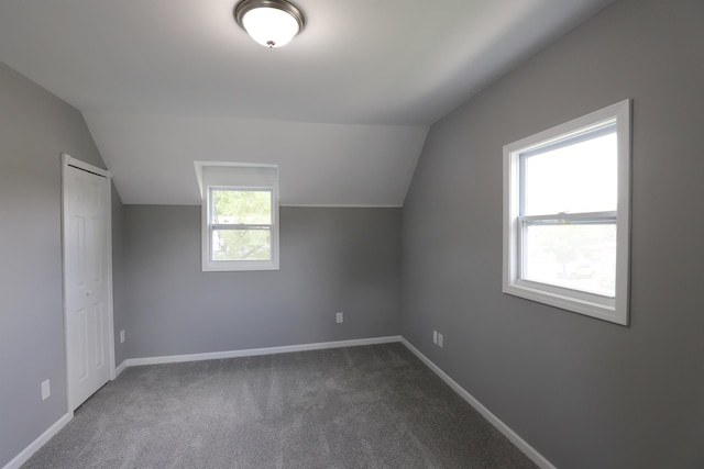 bonus room featuring carpet floors, a healthy amount of sunlight, and lofted ceiling