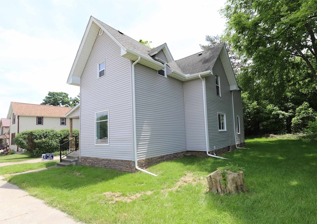 view of property exterior featuring a lawn