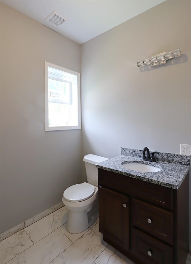 bathroom featuring vanity and toilet